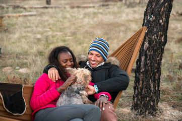 Couple with dog chilling in forest