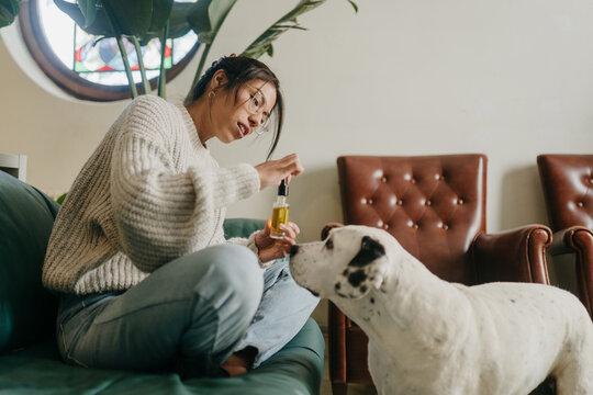Woman giving dog medicine