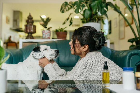 Woman giving pets to good dog