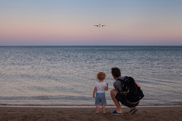 Obraz premium travel, father and child looking at airplane