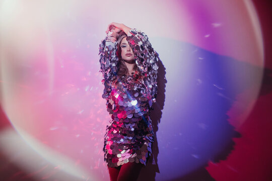 Surreal fashion portrait of woman in sequins dress