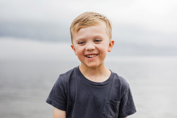 portrait series of a boy by a lake