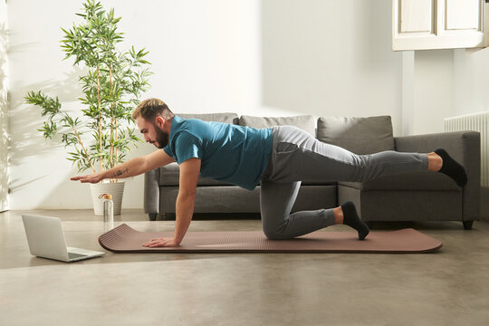 Man following a online exercise class