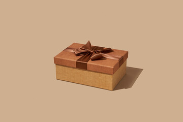 brown gift box tied with a brown satin ribbon