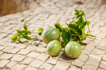Green Passiflora fruit. Passion fruit on stone surface