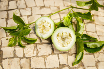 Green Passiflora fruit. Passion fruit on stone surface