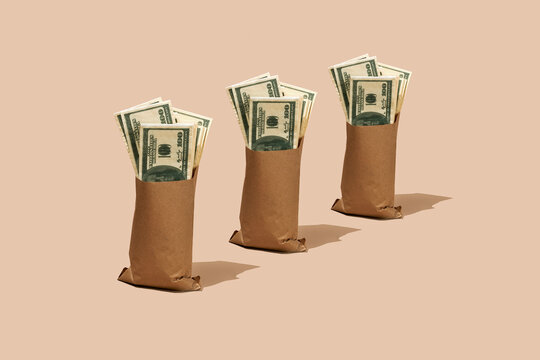 fake dollar bills in three paper bags