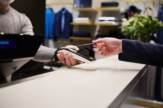 Anonymous customer paying with card in a menswear store