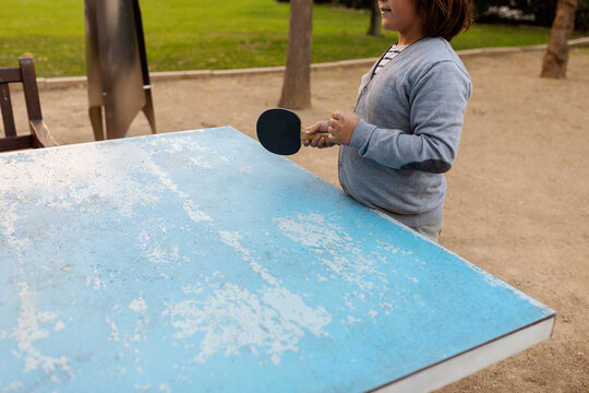 boy holding tennis table paddle