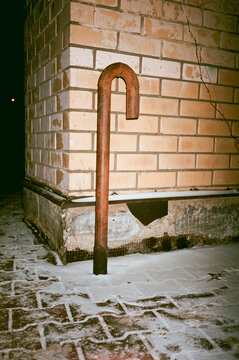 Brick wall and a water pipe at night with direct flash