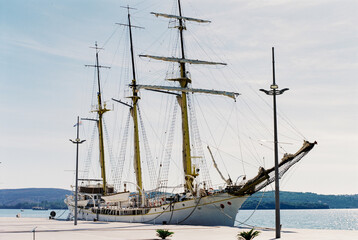 Fototapeta na wymiar Training sailboat Jadran is moored at the Tivat pier. Montenegro
