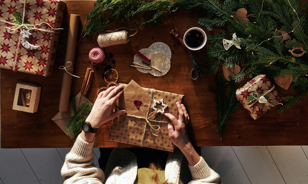 Woman's hands wrapping Christmas gift