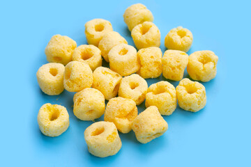 Roller corn snack on blu background.