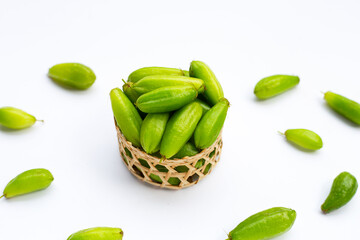 Bilimbi fruit in bamboo basket on white background.