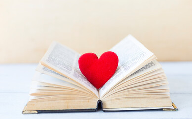 Love heart on old book with space on blurred background, wedding, love and romance symbol