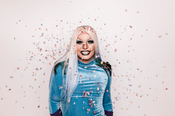 Happy drag queen with bright makeup and confetti