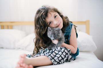 Young Girl holding a gray kitten