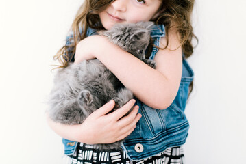 Young Girl holding a gray kitten