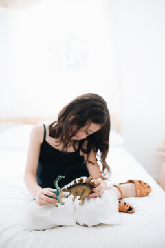 Siblings playing with dinosaur toys