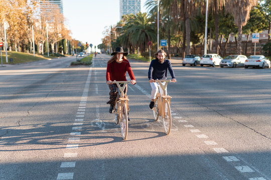 Friends riding eco bicycles on bike path