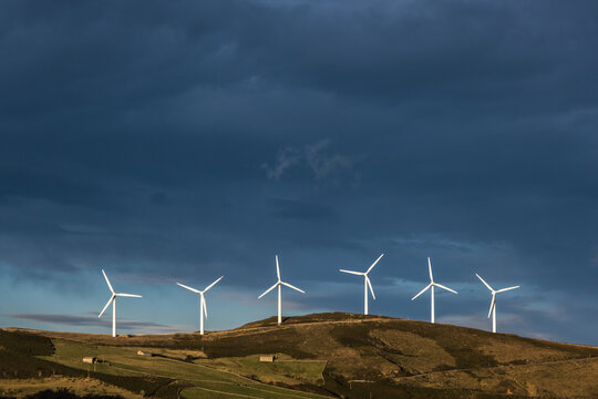 haldf a dozen of wind mills on a ridge