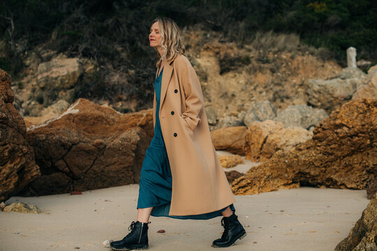 Woman walking on the beach during cold season