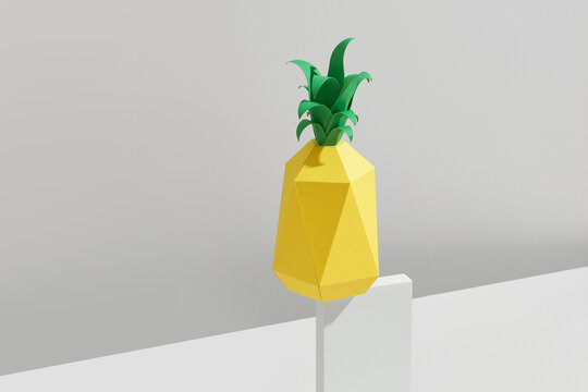Pineapple made of paper on podium