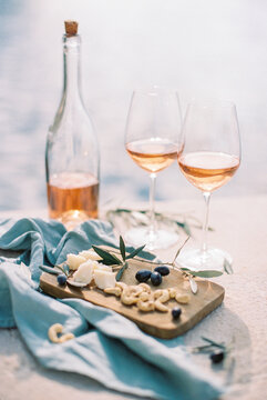rose wine with cheese and nuts by the sea