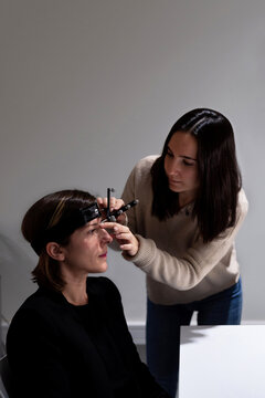Doctor measuring brain of patient with TMS