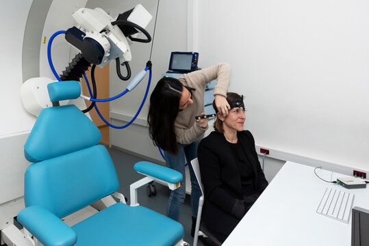 Doctor measuring brain of patient with TMS