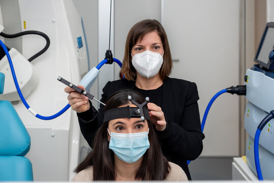 Doctor measuring brain of patient with TMS