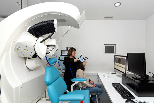 Researcher analyzing brain of patient with TMS