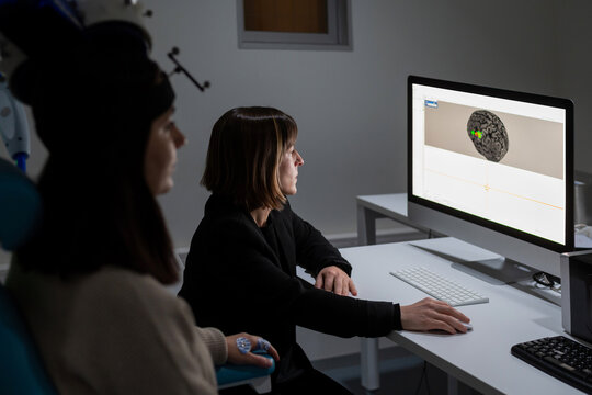 Researcher analyzing scan of brain of patient