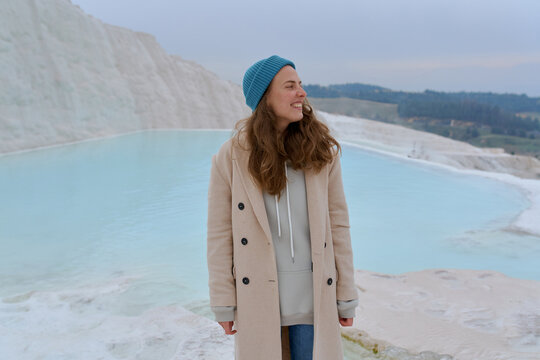 a woman in a light coat on a light background