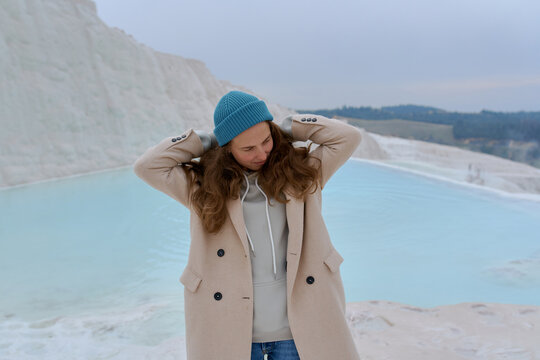 a woman in a light coat on a light background