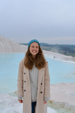 a woman in a light coat on a light background