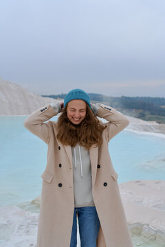 a woman in a light coat on a light background
