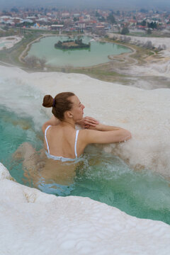 a woman in a pool from warm springs
