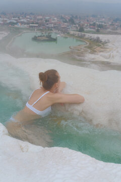 a woman in a pool from warm springs