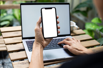 man hand using smartphone In the coffee shop,Screen blank with clipping path