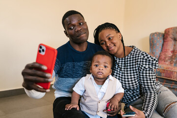 Loving gentle family taking selfie on smartphone