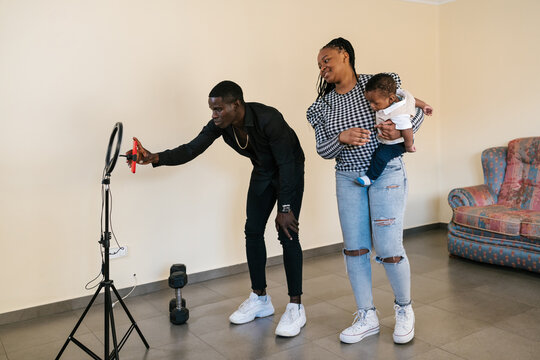 Man using smartphone for recording video with family