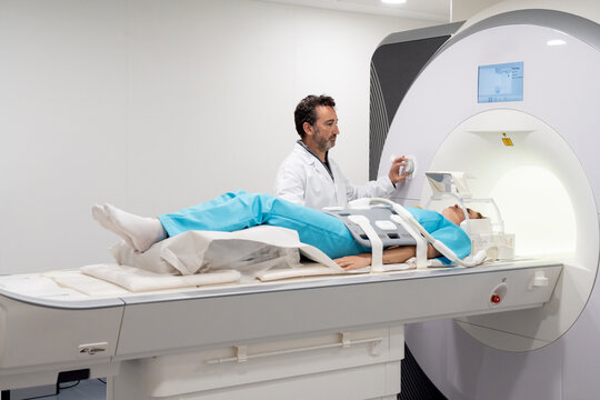 Doctor doing MRI procedure in clinic