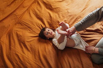 Woman Changing Baby's Diaper