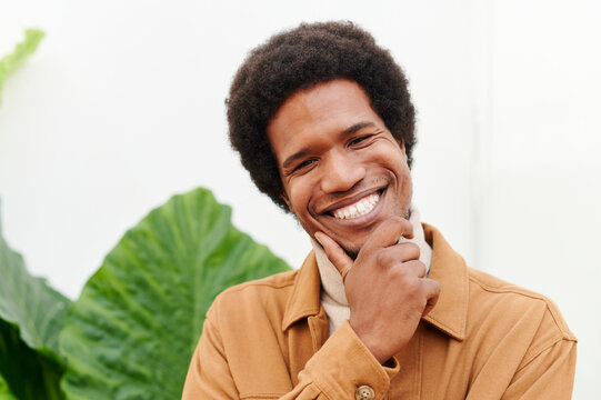 Smiling young man standing outside
