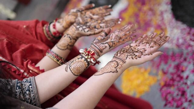 A Shot of Indian Girls showing Mehndi in their Hands at an Indian Wedding in New Delhi,India
