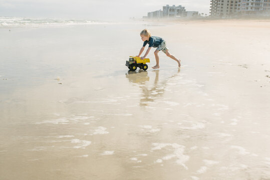 Boy with truck on the beach