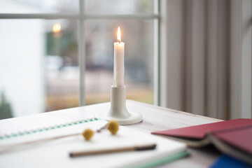 Single candle burning on table