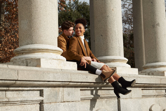 Couple back hugging at a classic column building