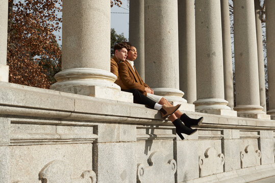 Couple back hugging at a classic column building